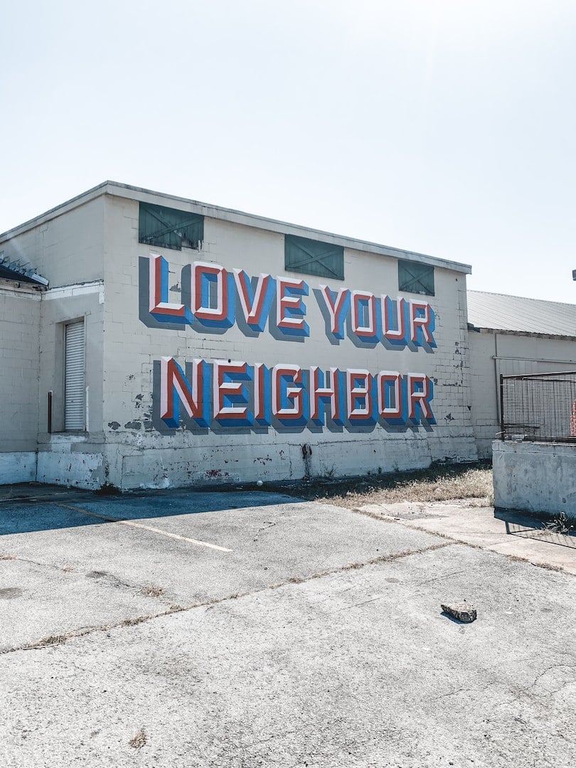 Love your Neighbor on old brick building